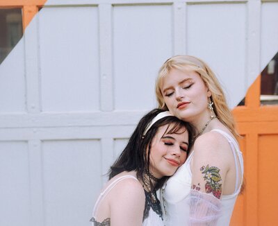 An indie LGBTQ+ couple’s moody editorial wedding portrait, photographed in a true-to-color style by Chelsea Stanford in Missouri.