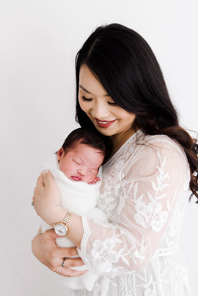 woman holding newborn baby taken by Boston Newborn Photographer