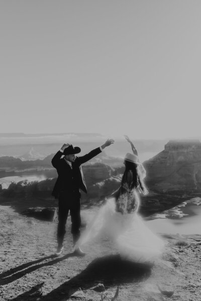 bride and groom dance on cliff