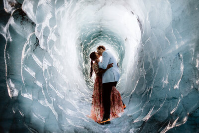 Married couple is kissing in an Ice Cave in Iceland on their wedding day