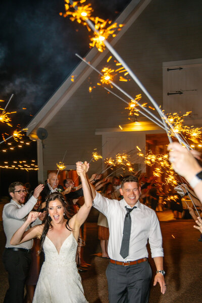 Bride and Groom celebratory moment running through sparklers at the end of the wedding