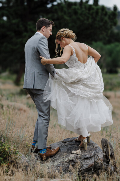Groom helps Bride during Rocky Mountain National Park adventure elopement.