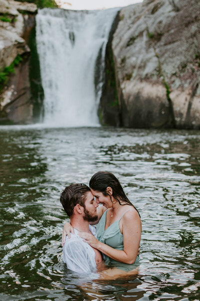 couple in the water during their engagement shoot