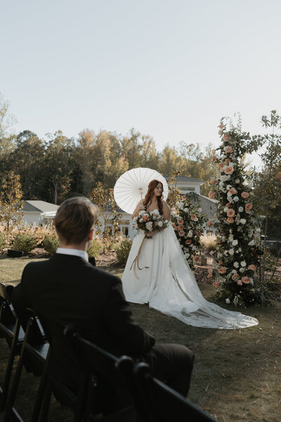 bride with parasol and modern satin gown at wrightsville manor