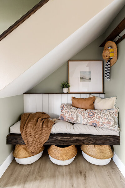 Under stair storage nook with bench, cushions and shelving