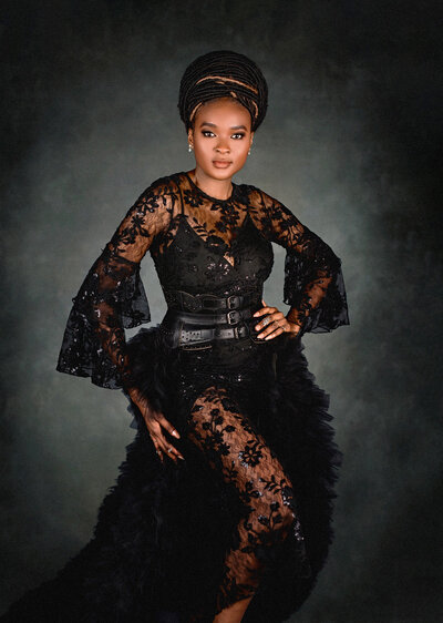 ung girl with red hair in a braided crown in a blue dress in a field