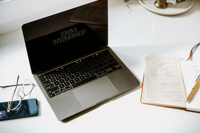 Laptop with copywriter Erika Fitzgerald’s logo displayed on the screen, representing her website copywriting and strategy services.