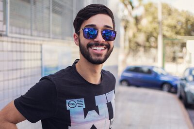 Male wearing sunglasses and smiling learning to live a healthy life with anxiety