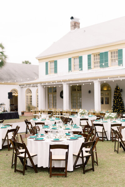 Elegant outdoor wedding reception setup with string lights and green accents, planned by The Eventful Gals in Northeast Florida.