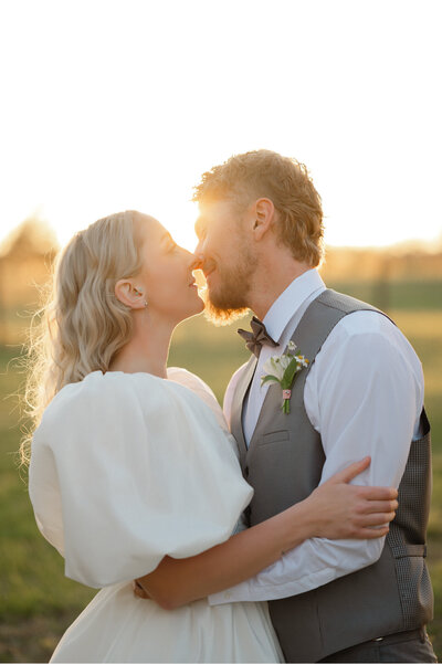 Newly engaged couple smile and look into the camera during their engagement session by Amanda Touchstone