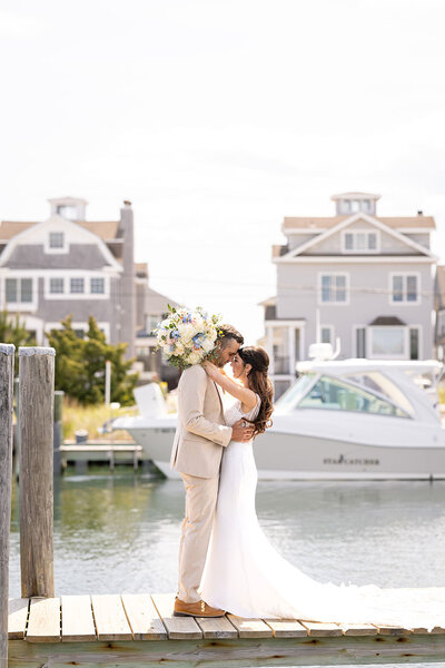 A couple in a close embrace on a dock.