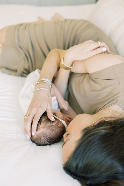 Mom-laying-on-bed-with-baby-in-Austin