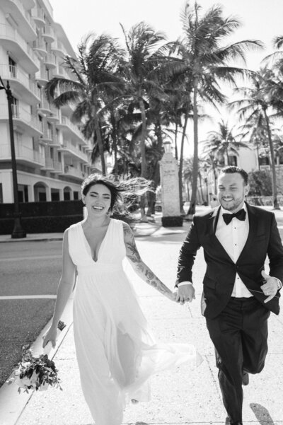 Couple running across the street in palm beach captured by Best Palm beach engagement photographer