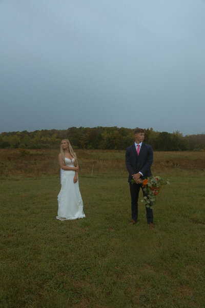 Cinematic bride and groom taking portraits for their backyard Missouri wedding