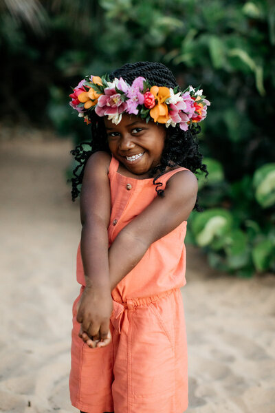Anaya Henry smiling big for the camera with a flower crown.