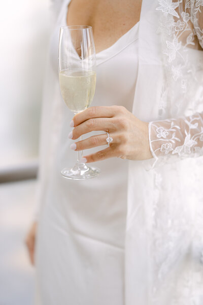 Bride holding champagne