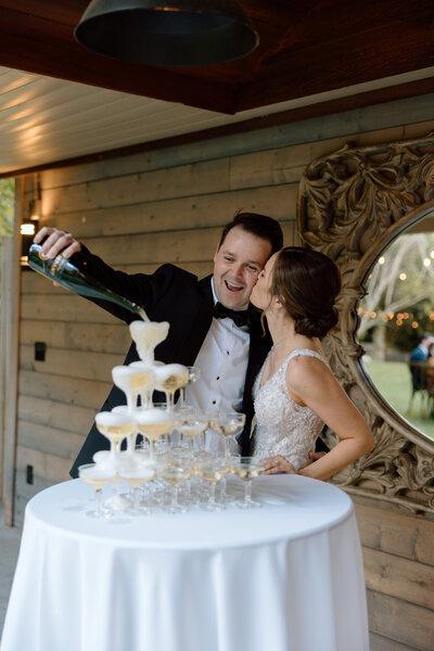 Southern California Fallbrook Wedding Couple pouring Champagne on a Champagne Tower 