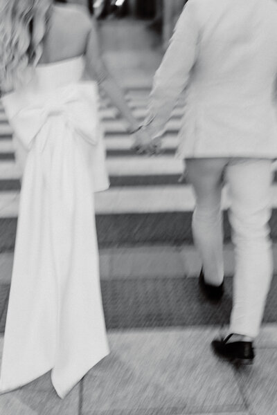 Bride and groom run down the beach hand in hand - Elopement photography Sunshine Coast