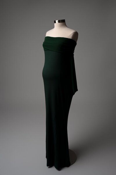 Fitted dark green maternity dress with strapless neckline – styled on mannequin for studio session wardrobe