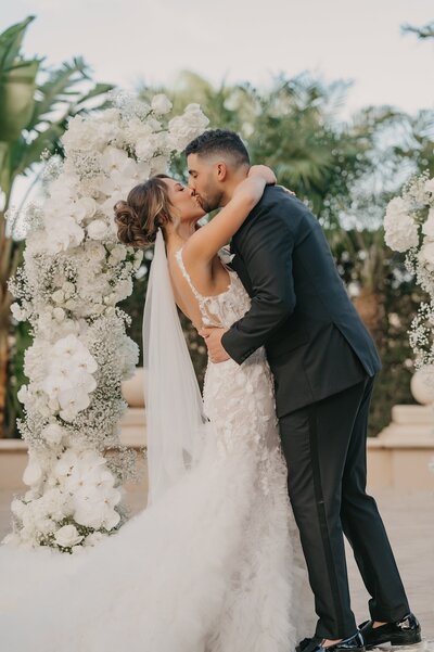 Bride and groom kissing at The Club at The Strand wedding ceremony