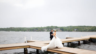 bride leading groom off of pier
