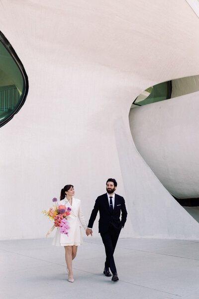 retro TWA hotel wedding architect and curator with blazer dress and rainbow bouquet by bloom bloom