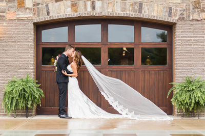 White textured wedding bouquet with greenery crafted by Bouquet Studio and photographed by Loren Jackson Photography at Gervasi Vineyard in Canton Ohio