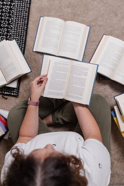 Laura reading from an open book in her lap