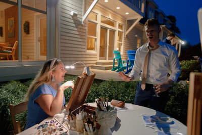 A bride and groom share a kiss in front of their opulent wedding reception decor at Trinity Cathedral