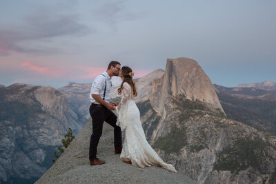 First kiss in the fading Yosemite sunset with Half Dome as a backdrop -- we couldn't be Yosemite elopement photographers without Half Dome in some pics!!