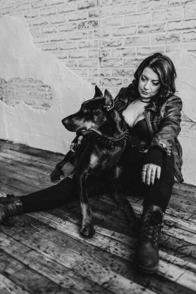 woman sitting next to her pet dog