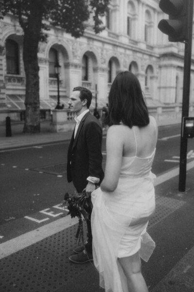 A & J kissing as they pop a bottle of champage