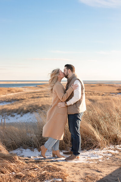engagement photo on cape cod beach couple kissing
