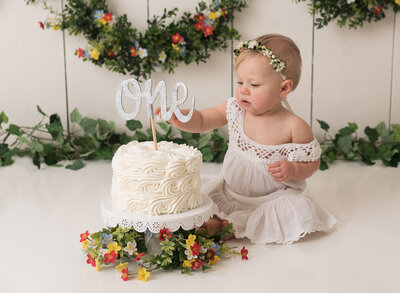 Adorable baby girl in a flowery themed cake smash session in Houston