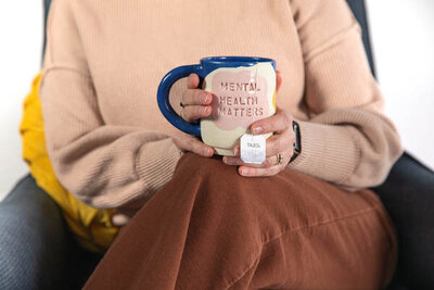 Lori with her favorite "Mental Health Matters" mug in therapy