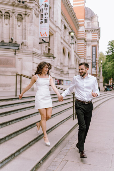 Engaged couple walking at the Victoria and Albert Museum in London, UK, captured in a candid documentary photography style