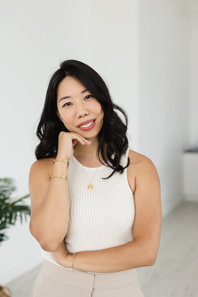 A professional solo portrait of a career woman in a studio.