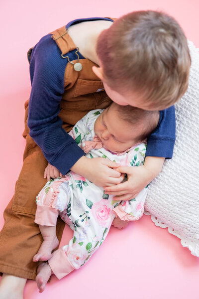 Brother holding baby sister | Maine Newborn Photographer