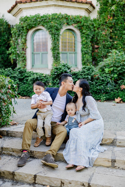 mom and dad kiss on steps