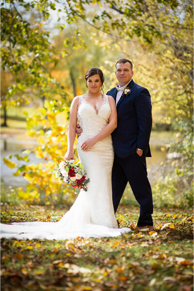 Bride and groom pose for wedding portraits in nature