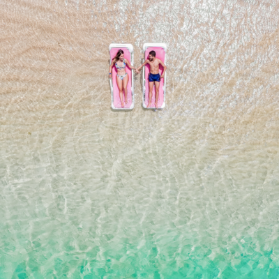 honeymoon couple holding hands on beach