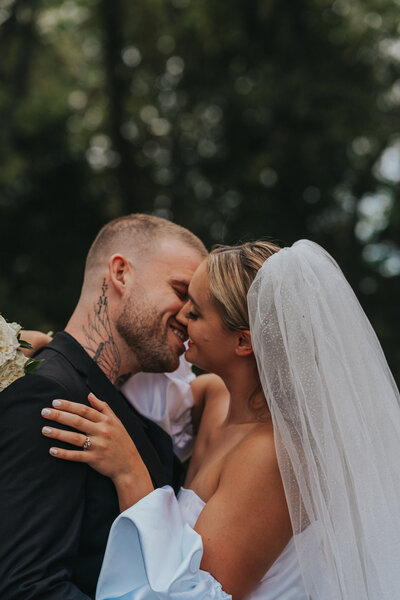 Heavily tattooed newlyweds kiss