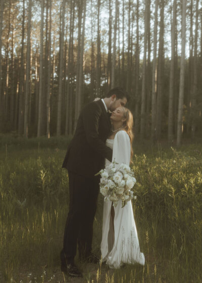 bride and groom in forest during golden light hour 