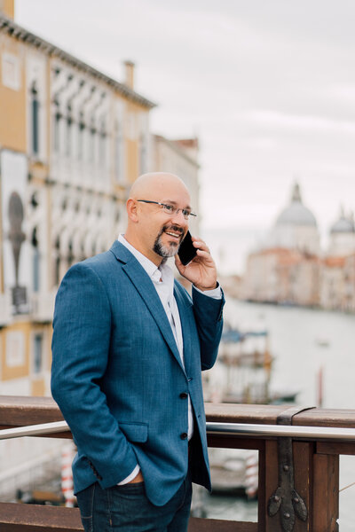 Sam Jacobson, business coach for wedding professionals, on a call in Venice.