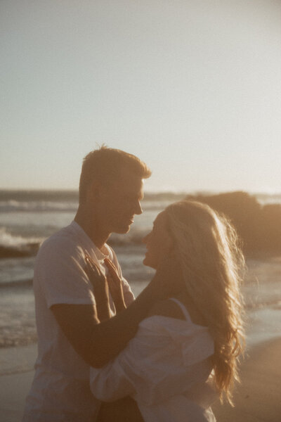 couple embracing on beach in australia