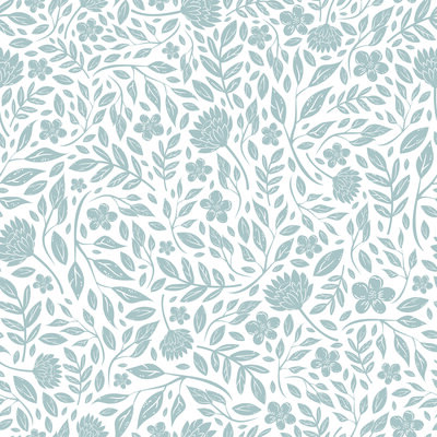 Aubre wearing a white button down shirt standing in front of a sun drenched window