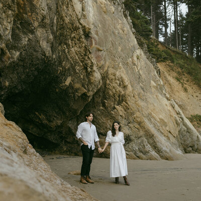 Couple sitting on rocks on the beach