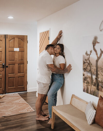A couple sharing intimate, candid moments during an in-home photoshoot in Los Angeles, capturing their love in a cozy, natural setting.