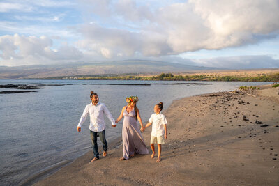 Sunset beach family portrait holding hands by a Big Island family photographer
