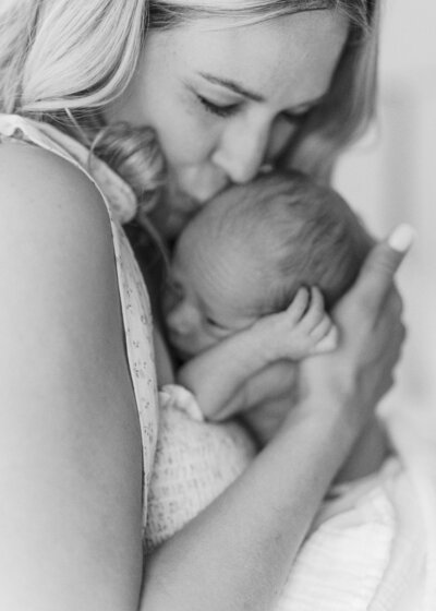 Woman in white dress holding hand of little girl